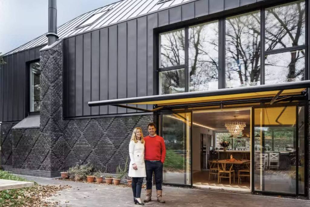 Owners of Danny Cottage and Studio standing outside their Airbnb property